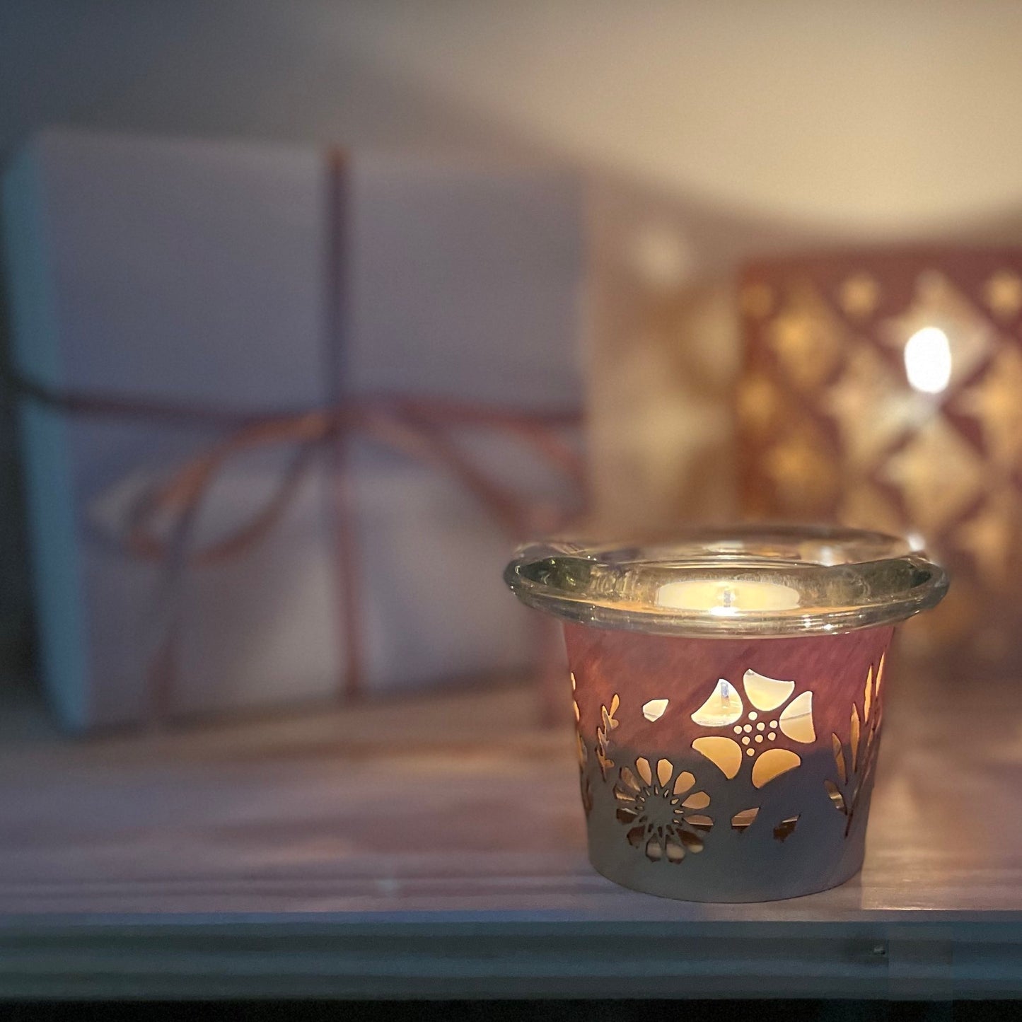 a tea light holder with a floral design handmade in maple and glass