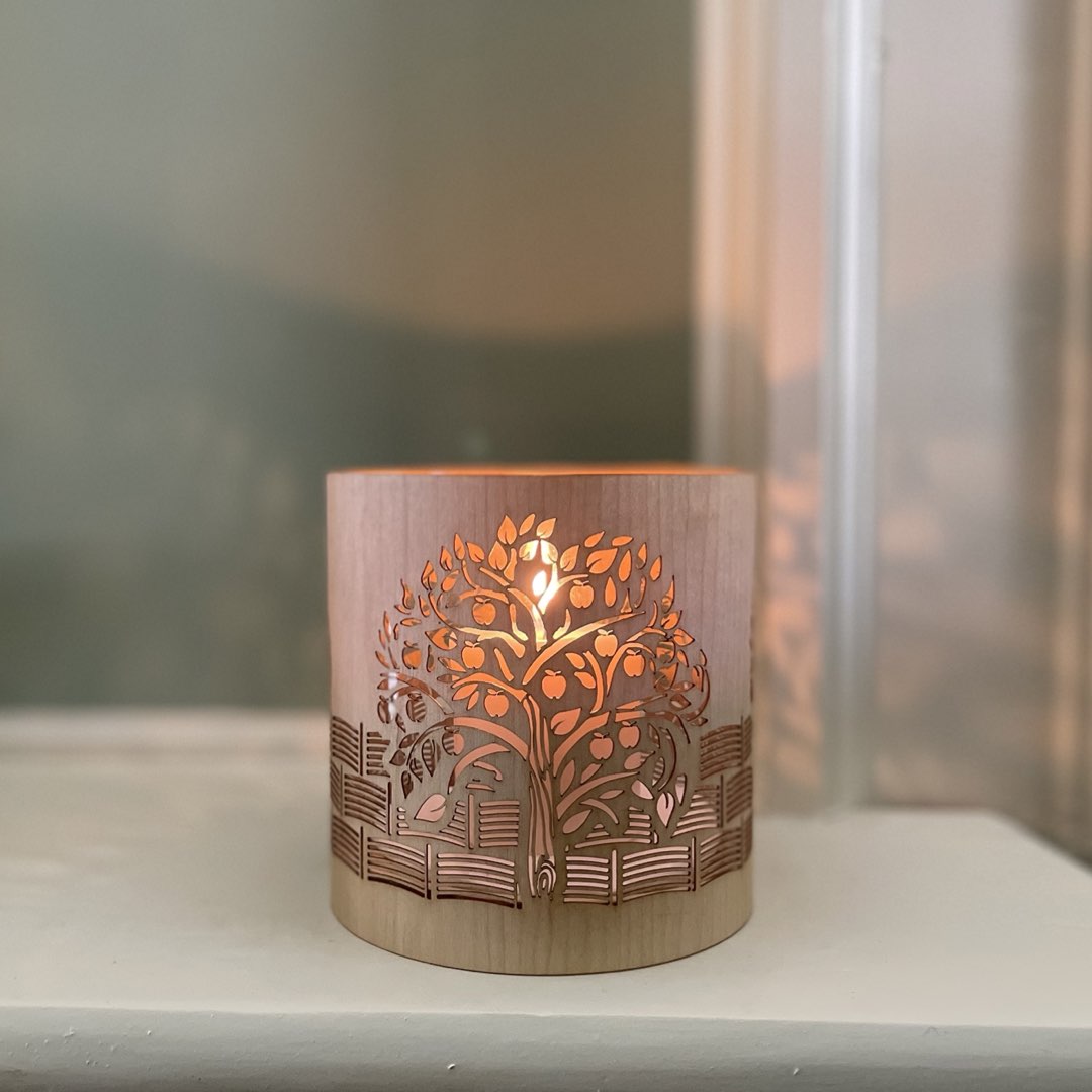 A candle holder or lantern with an apple orchard design iinspired by kelmscott manor