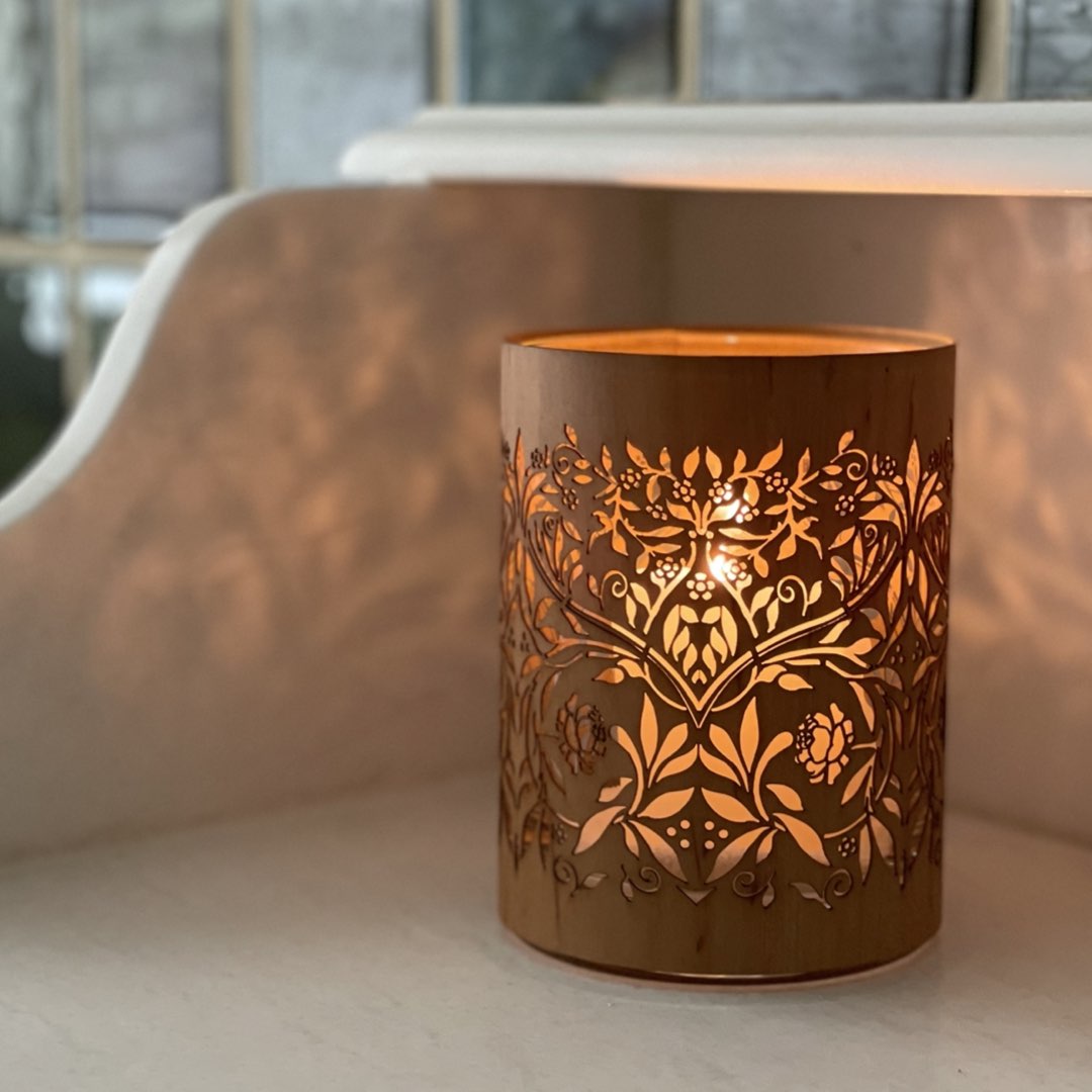 s small william morris candle with a floral patten lit