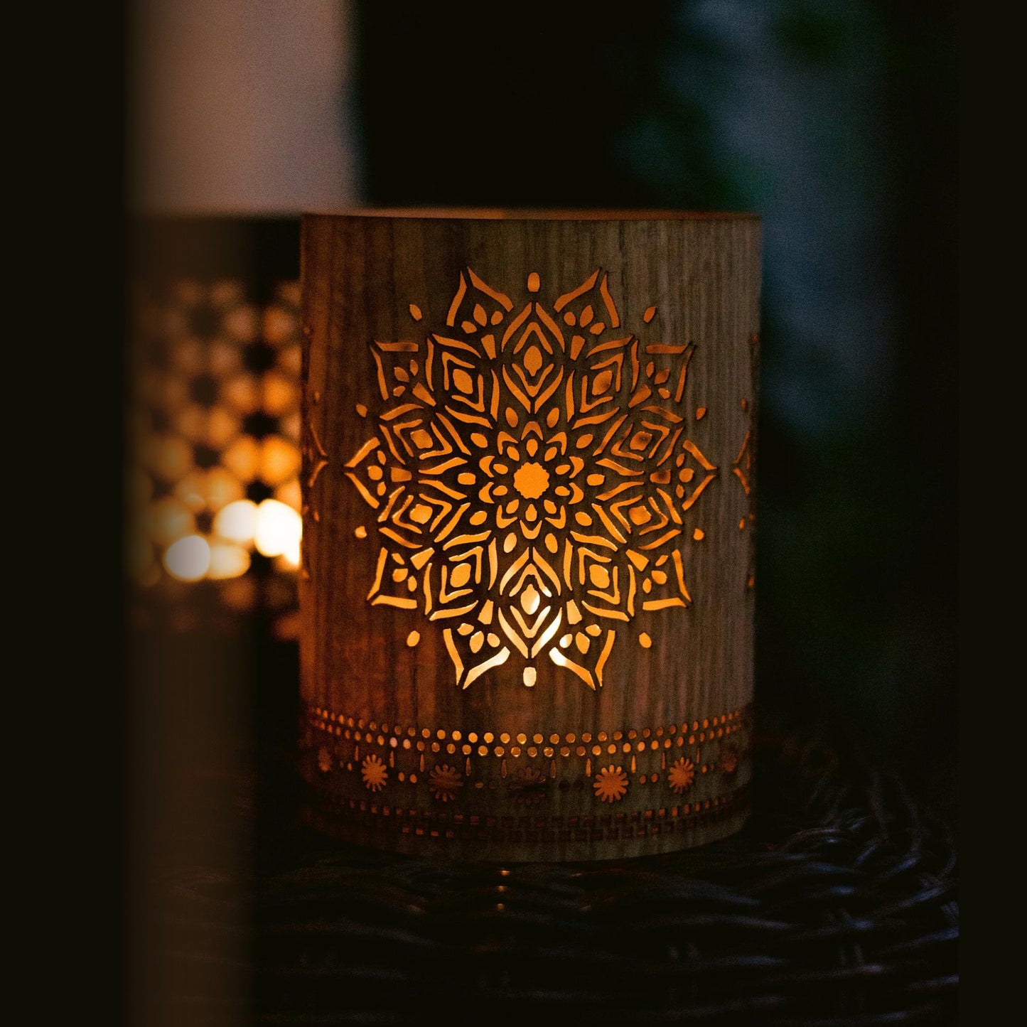 small oak mandala lantern in lit in the august evening