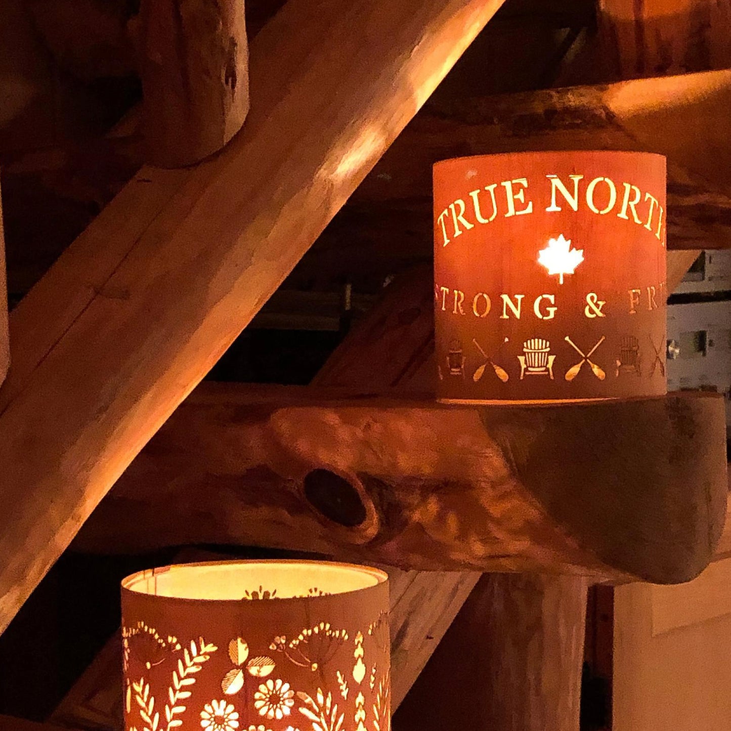 true north strong and free lantern on the steps to the loft of a log cabin Weslemakoon lake