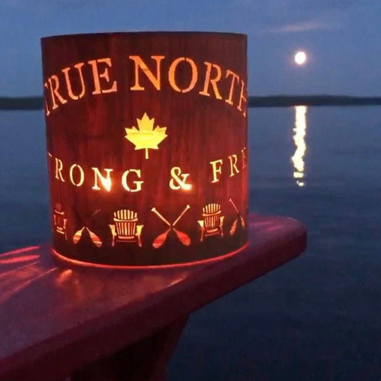 A true north lantern - medium in White Oak on the arm of an Adirondack in Muskoka