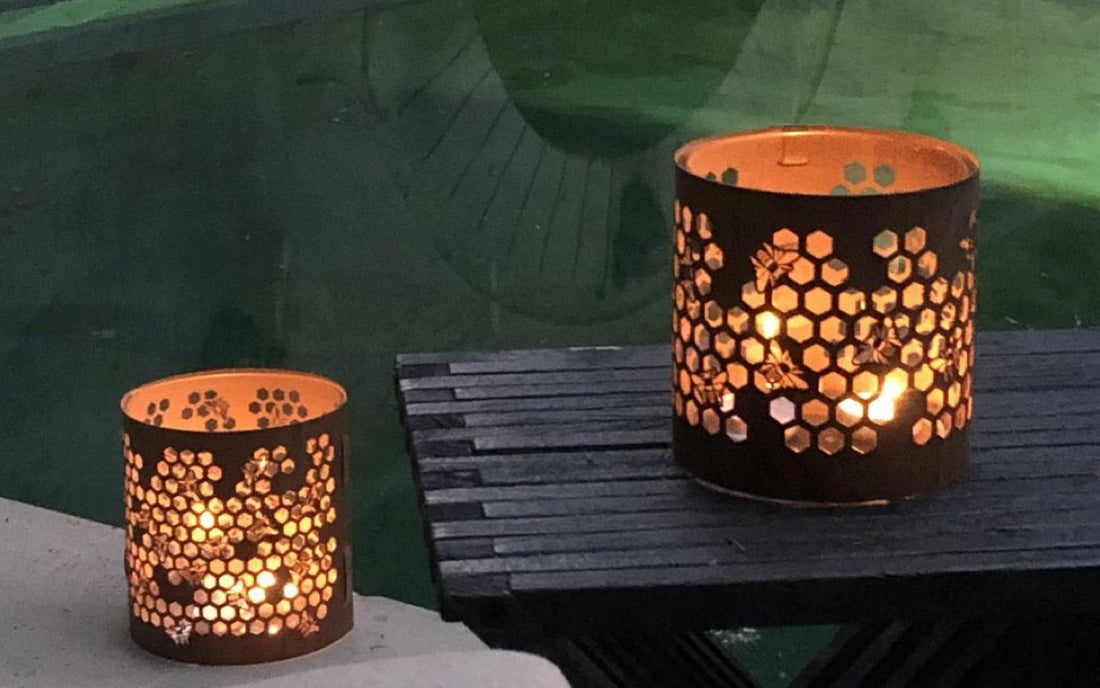 Two honeybee lanterns by the side of the pool  in the evening July 2020 