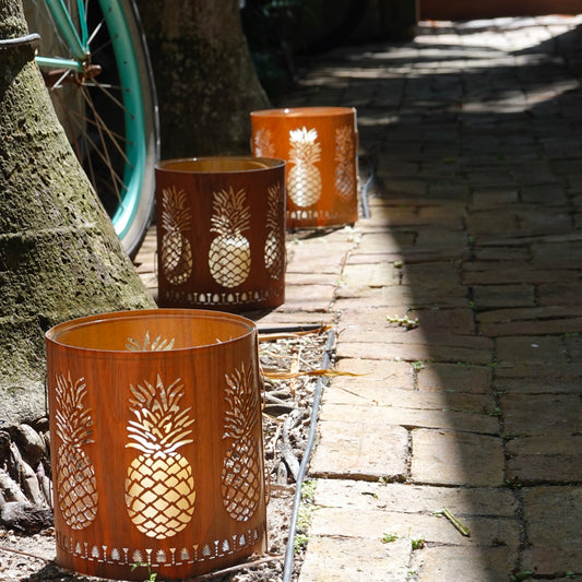 a series of wood and glass pineapple lanterns on a lane in Key West