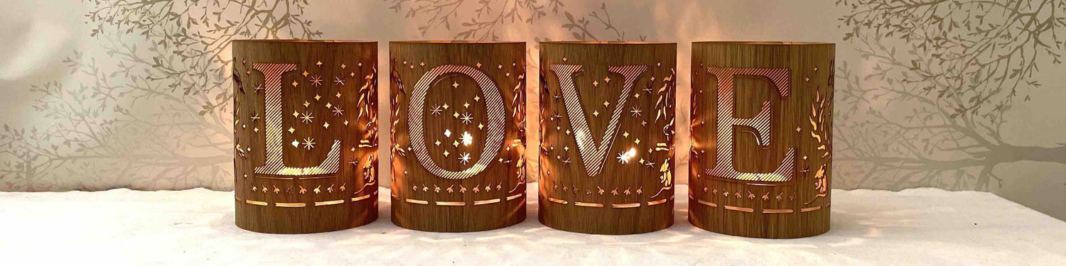 Four monogram lanterns lit that spell out the word LOVE