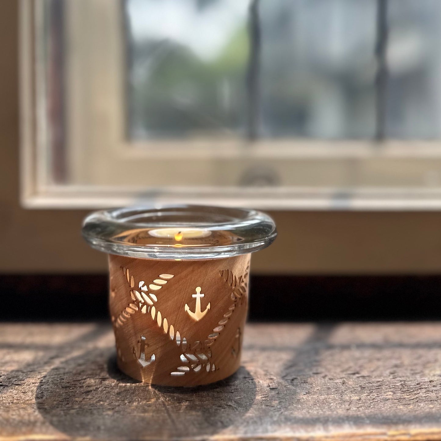 a tea light holder with a nautical design handmade in maple and glass