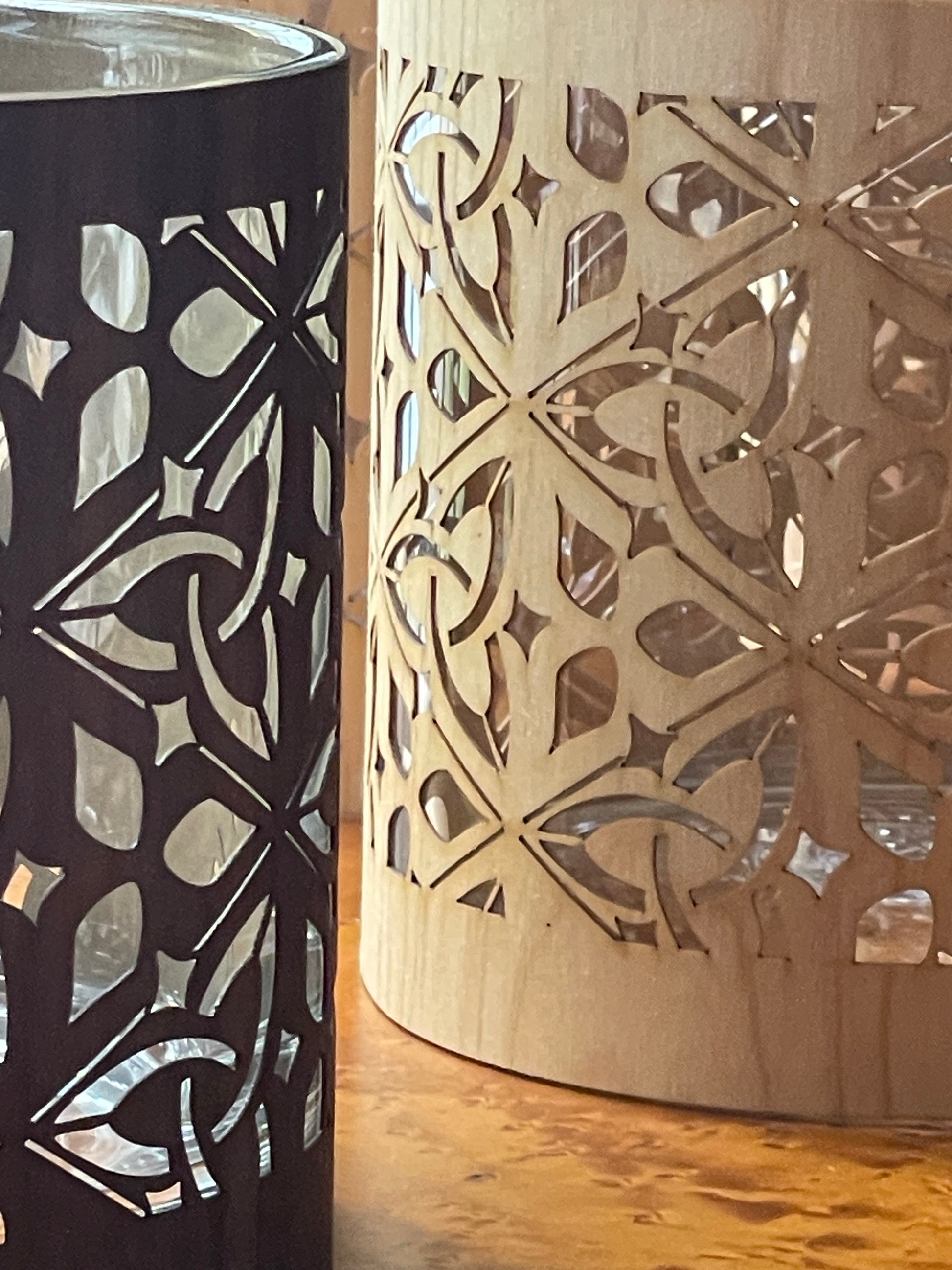 Close up of a triquetra design rendered in black walnut and maple over glass to make a lantern
