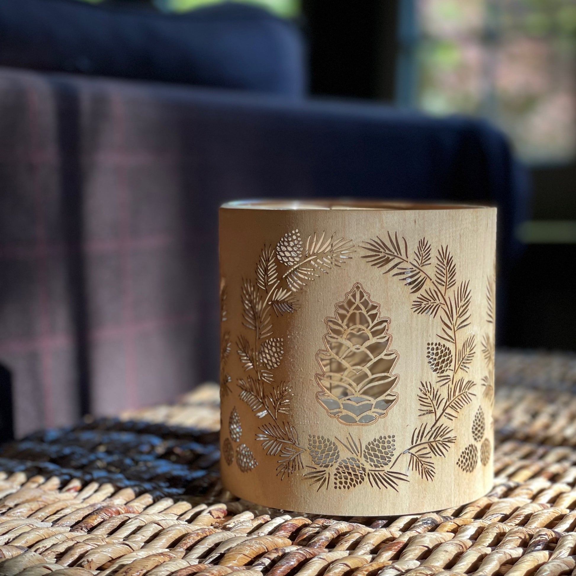 a wood and glass candle holder lantern in maple in the daylight