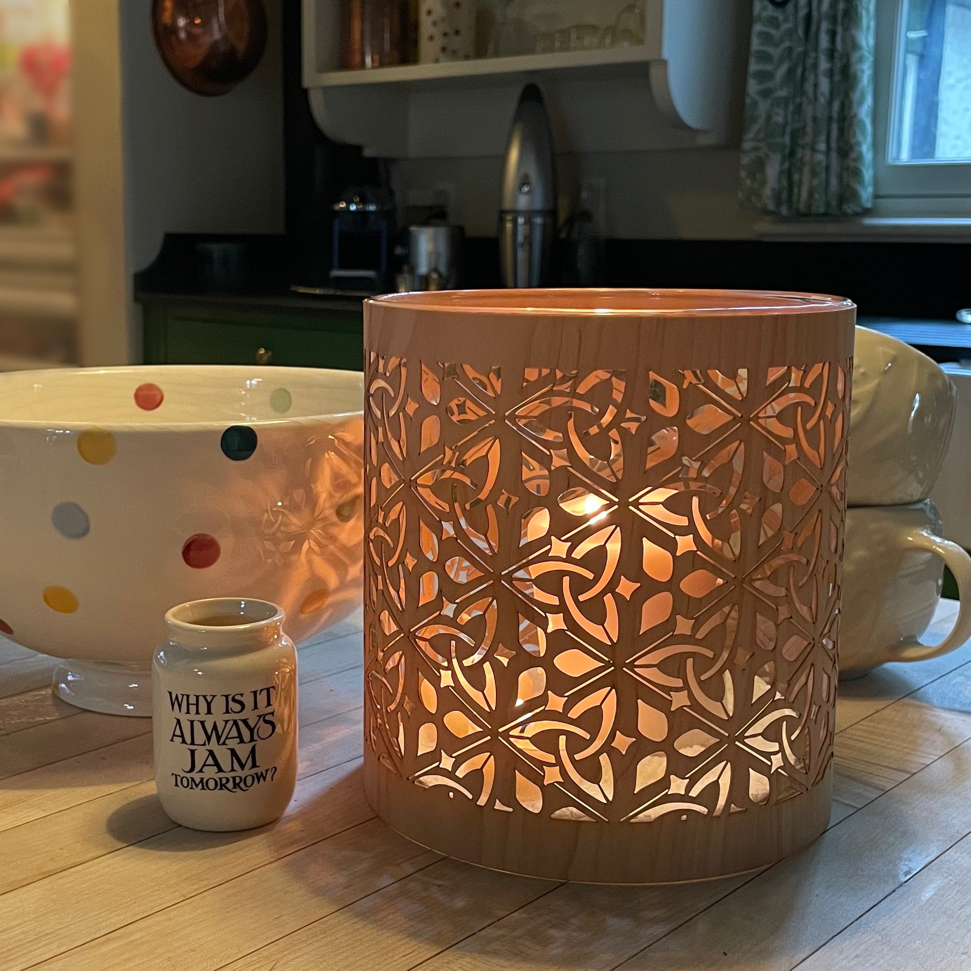 Atmospheric wood and glass lantern from the Celtic Collection featuring the Triquetra motif, on my wooden kitchen counter