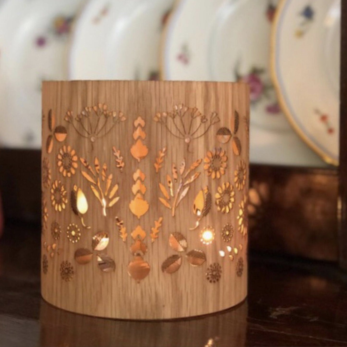 close up of the medium White Oak floral lantern lit on a welsh sideboard