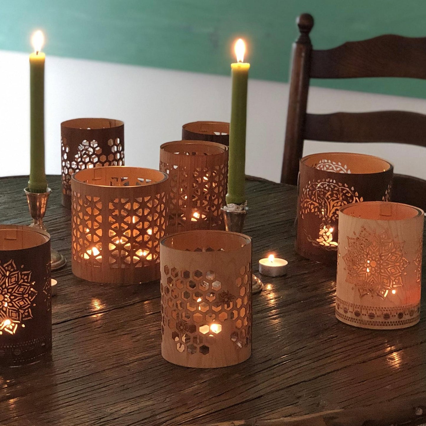 a selection of lanterns of different designs and sizes with a small maple honeybee lantern in the foreground