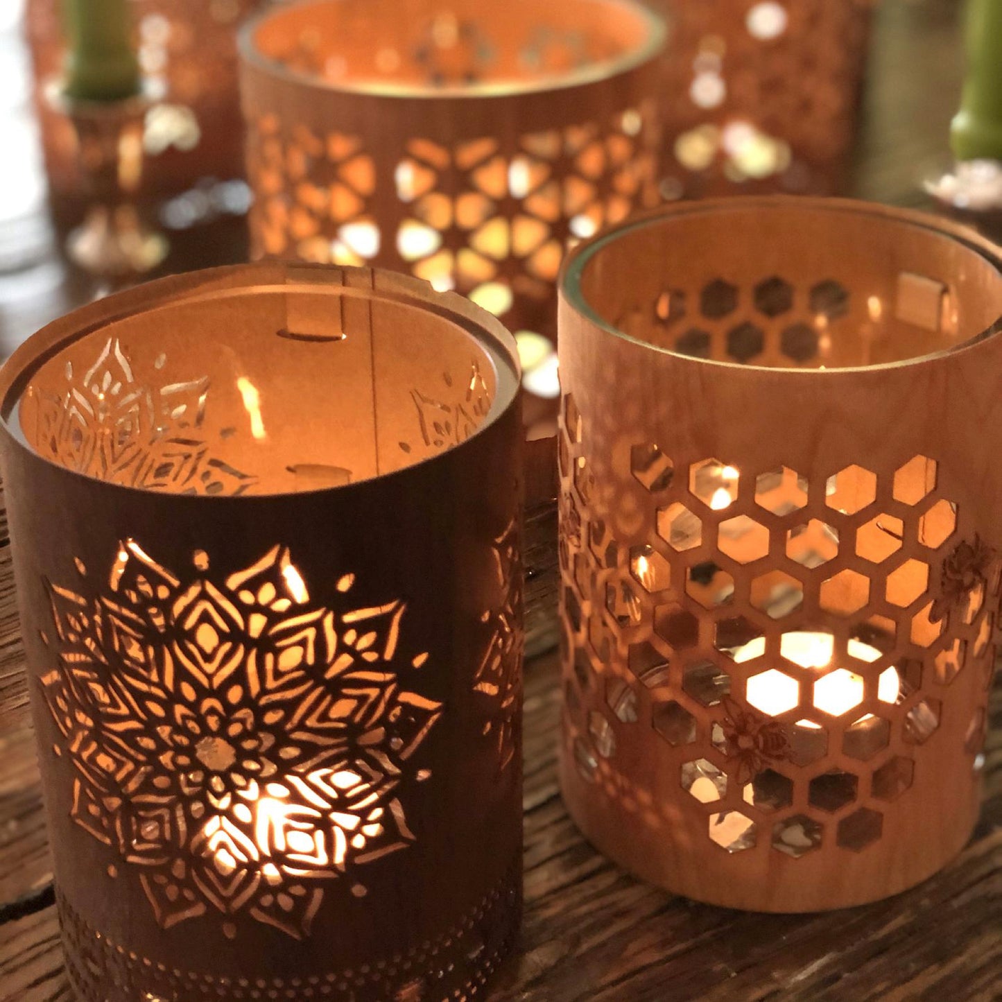 small maple honeybee lantern beside a small Black Walnut mandala lantern