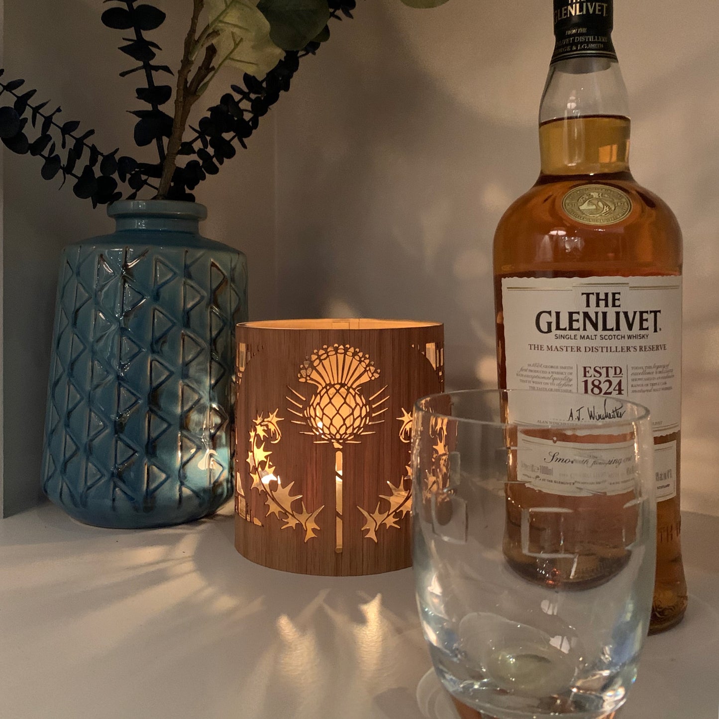 thistle art lantern in medium white oak  lantern cozy with a bottle of The Glenlivet