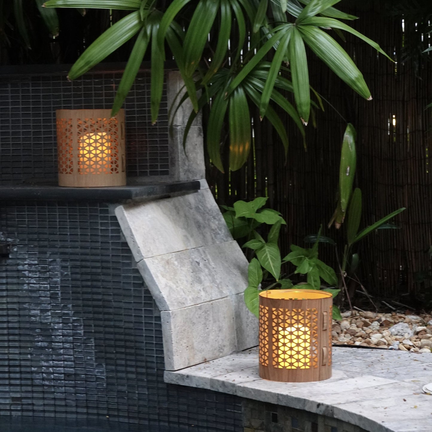 Two large mid-century modern lanterns, maple and White Oak by a pool in the garden of a home in Key West