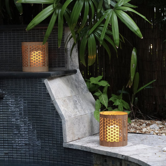Two large mid-century modern lanterns, maple and white oak by a pool in the garden of a home in Key West