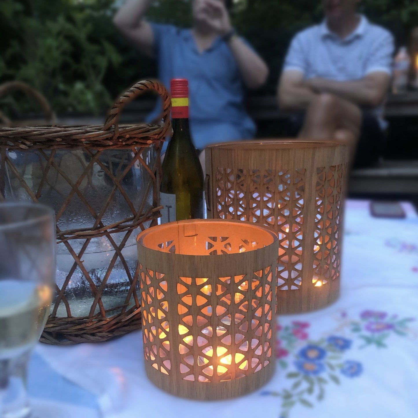 A medium and a large white oak mid-century modern lantern on a summer's eve