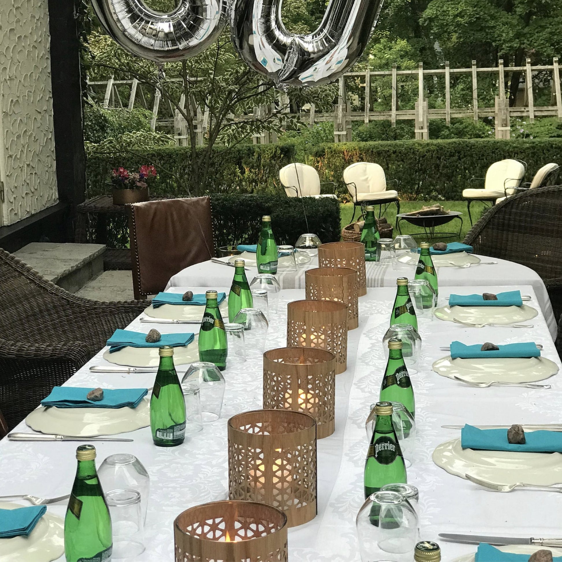 a birthday table laid with a series of mid-century modern lanterns