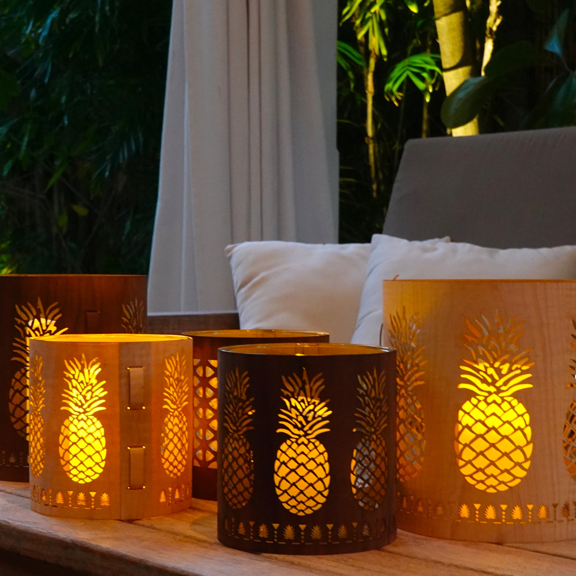 a selection of pineapple lanterns on a coffee table in key west
