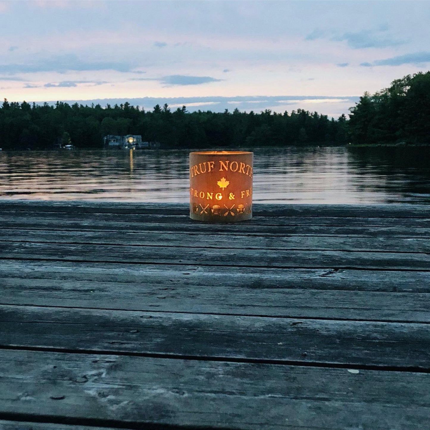 a true north lantern in medium white oak on a deck by Memphremagog